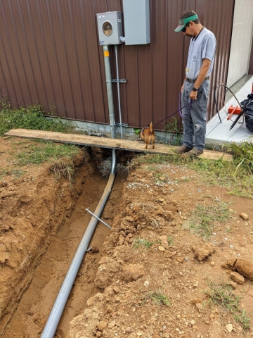 Dig trench and connect pipes for new barn