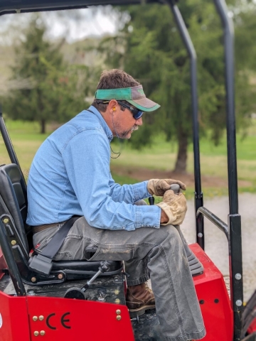 Adam Lazenby running a skid steer